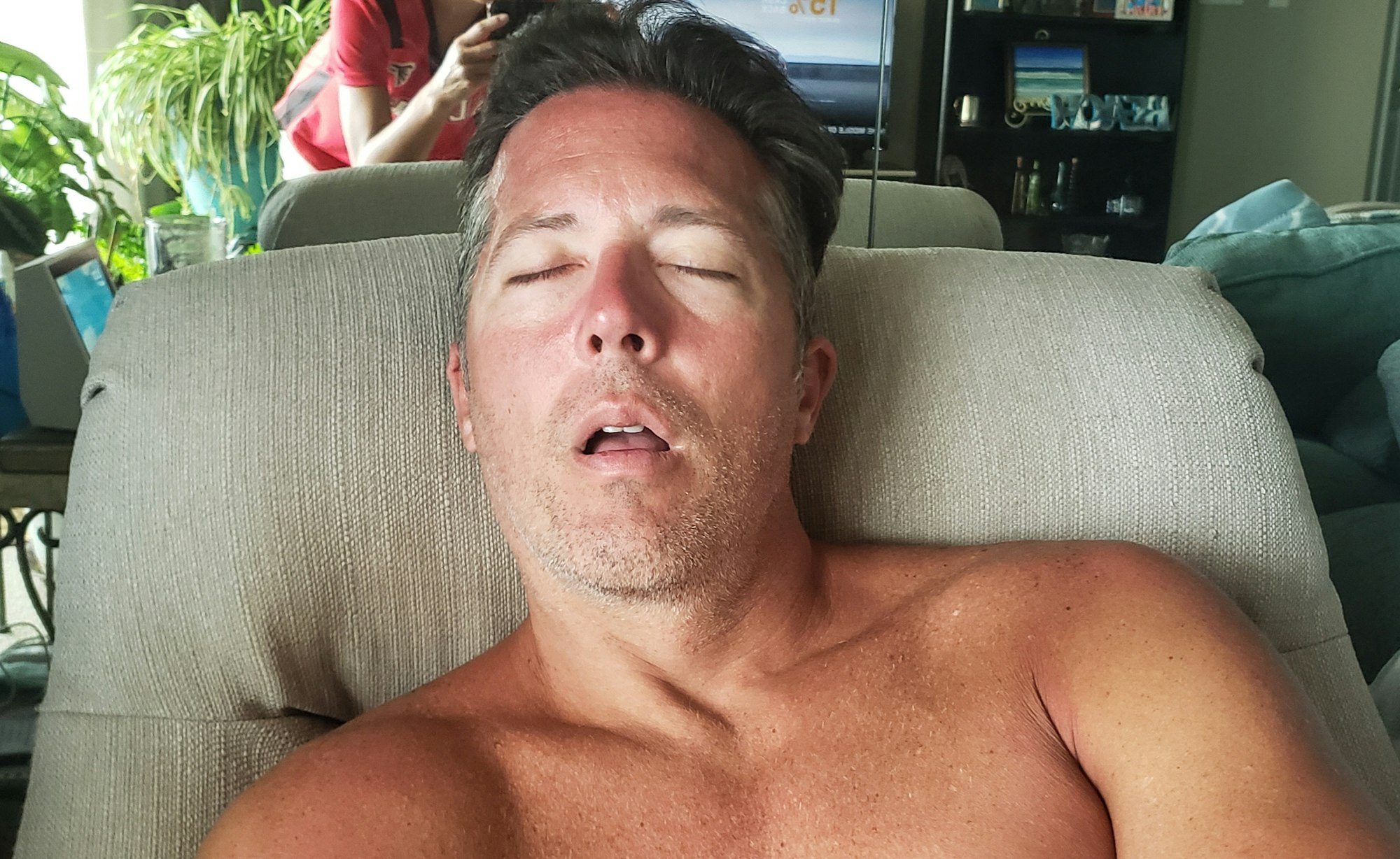 man sleeping in chair because of fatigue